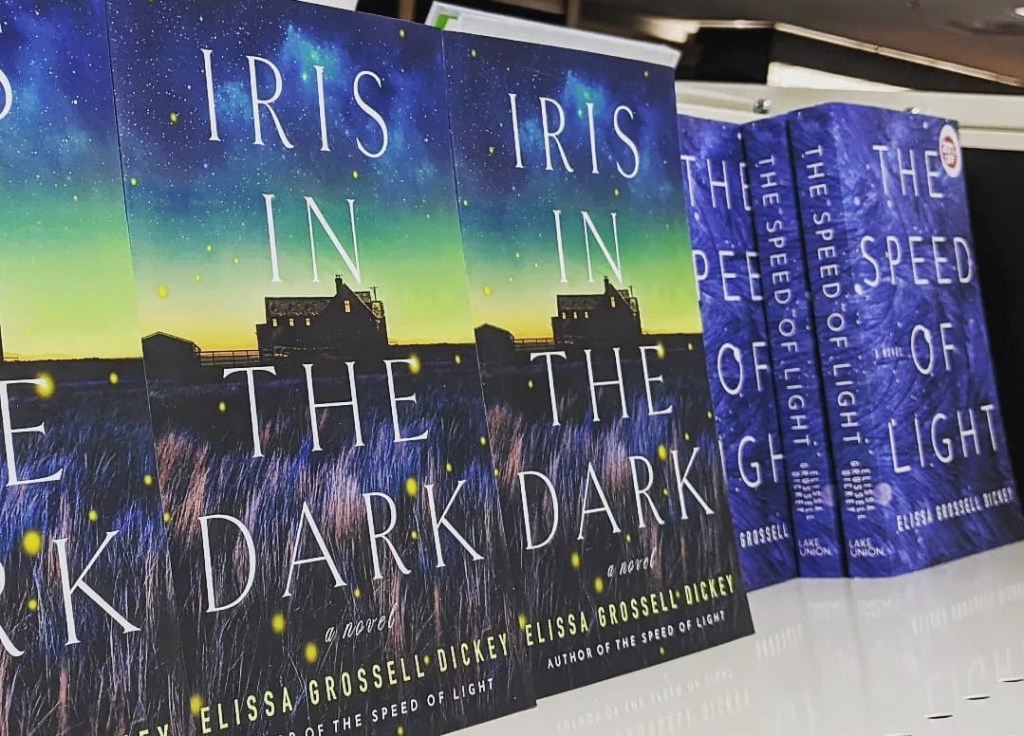 Copies of Iris in the Dark and the Speed of Light on a bookstore shelf